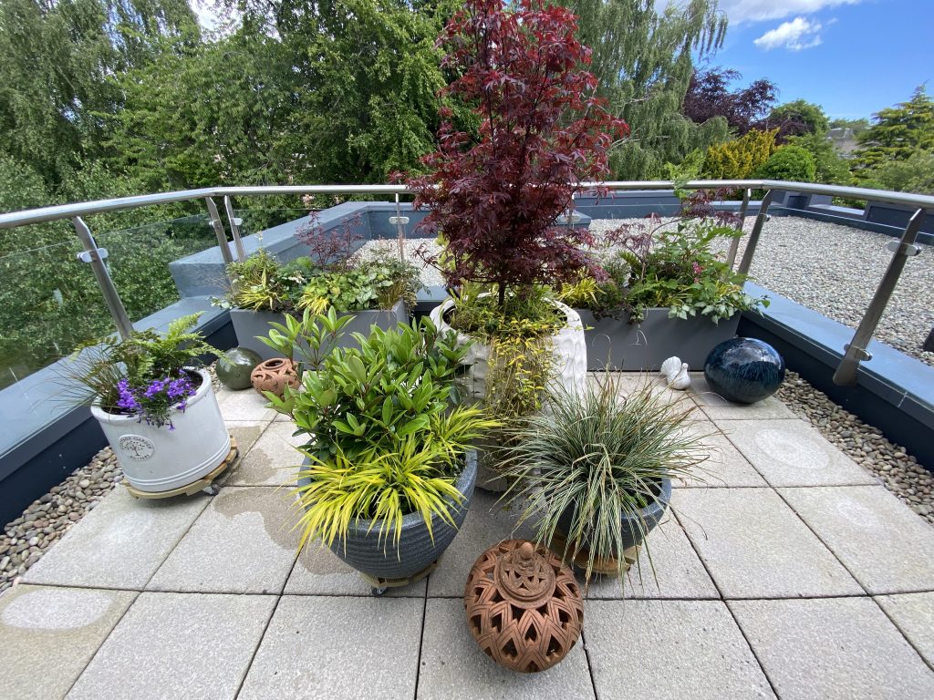 Stylish tall planters with lush greenery and floral accents.