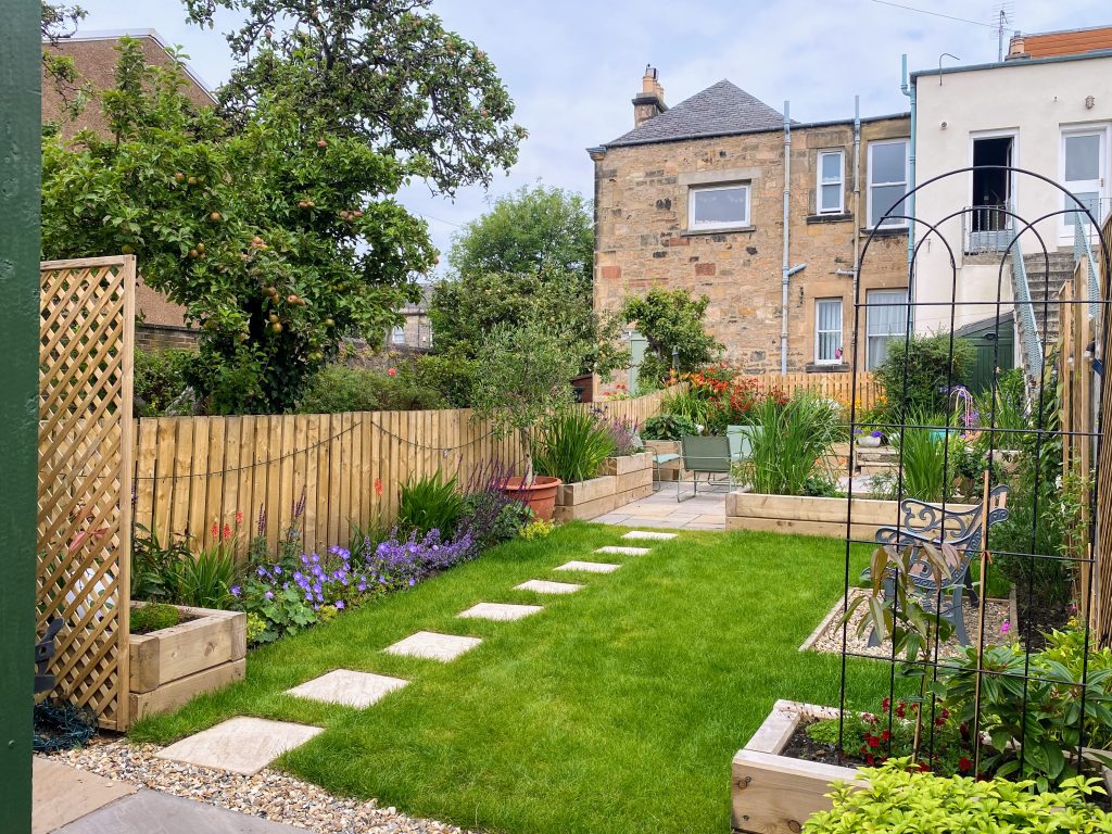 Charming garden with stepping stone pathway.