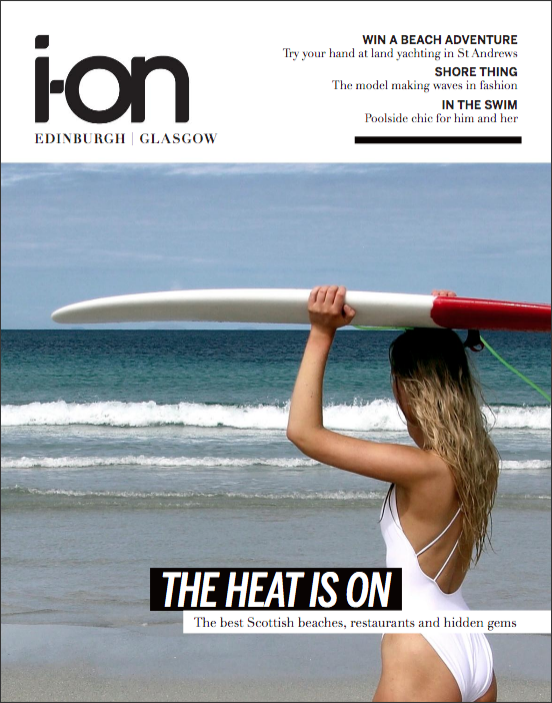 Cover of i-on magazine with a beach theme featuring a model holding a surfboard.