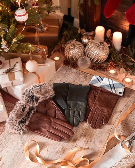 A flatlay of Barbour luxury leather gloves arranged with Christmas gifts, styled by Angela Moffat, Stylist, Edinburgh, Scotland.”