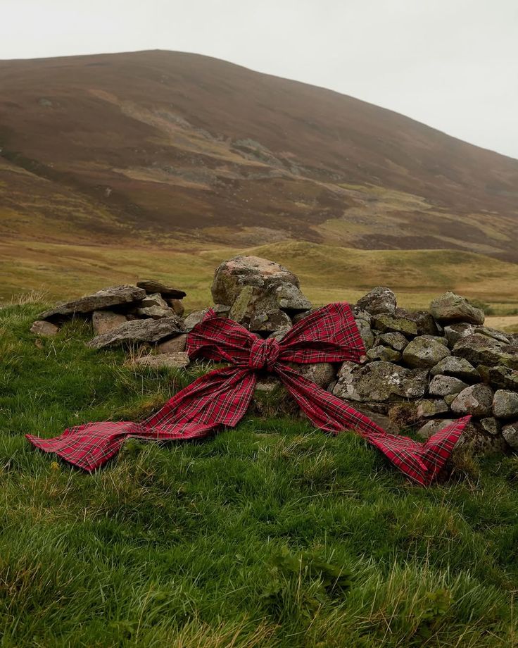 Large tartan bow tied to a dry-stone wall in the Scottish Highlands, styled by Angela Moffat, Stylist, Edinburgh, Scotland