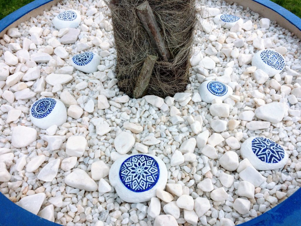 Unique stone garden feature with blue and white tile accents